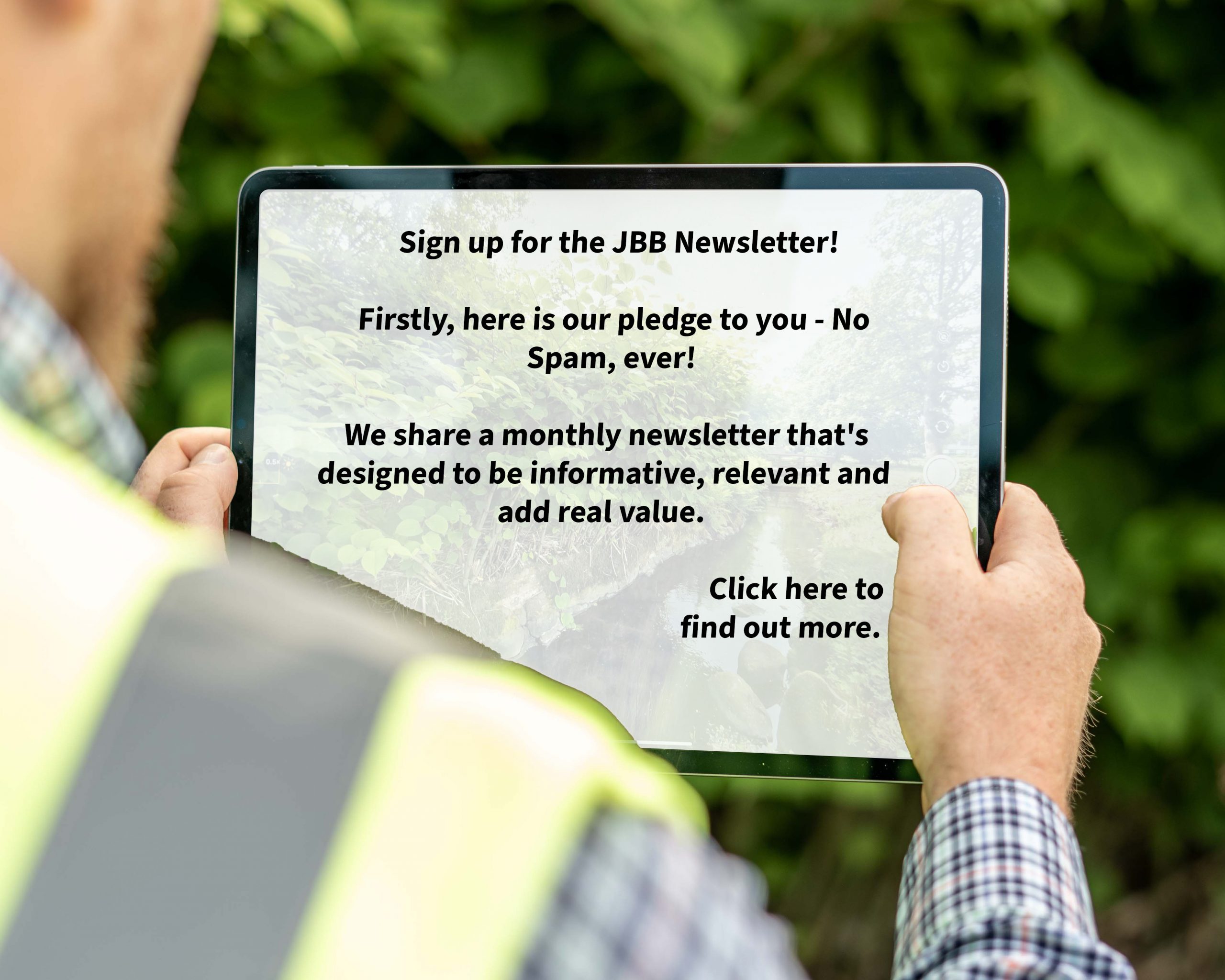 Man holding an iPad horizontally that displays a message about JBB Knotweed Solutions' monthly newsletter